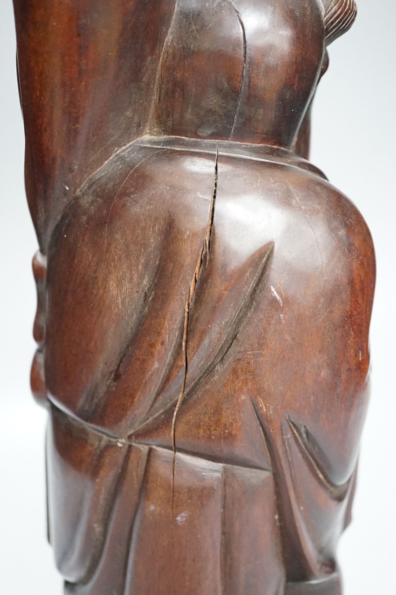 A Chinese hardwood figure of an immortal, 36cm